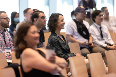 Audience members paying attention and smiling