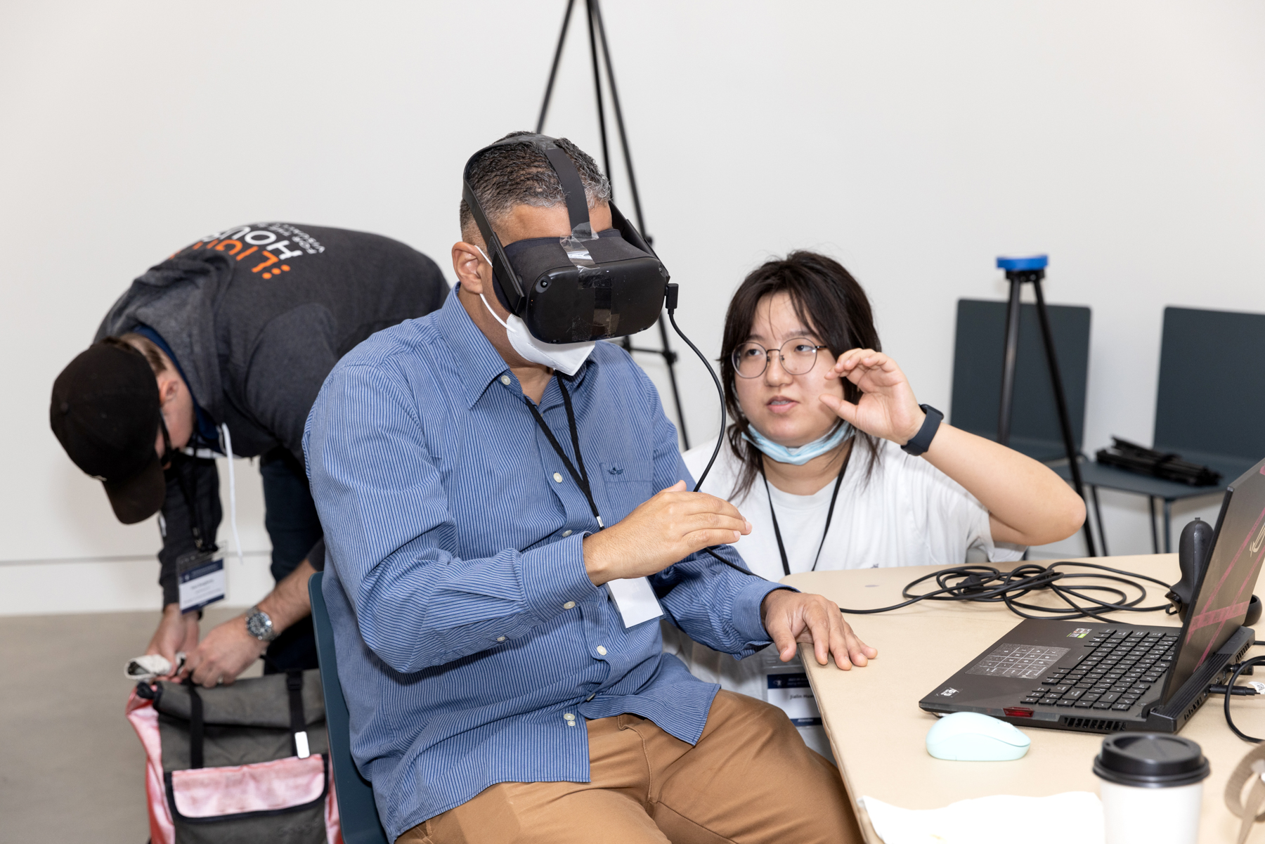 Jeffrey Colon tries a VR soundscape experience, assisted by a volunteer