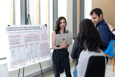 Ria Gualano stands in front of her poster titled 