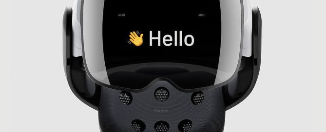 Cognixion One head-mounted display. It has a dark visor with a waving emoji and "Hello" on the front, and brain-computer interface nodes on the back.