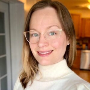 Headshot of Lorna, a white woman with blonde/brown hair and glasses.