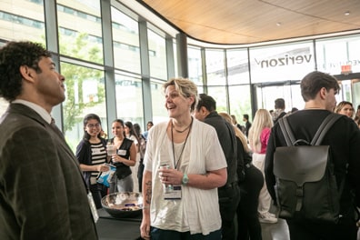 A woman laughs amidst the crowded lobby of the Verizon Center during a snack break.
