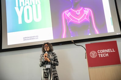 Dr. Judite Blanc, a smiling brown woman with a beautiful afro, presents a Thank You slide with a glowing avatar from her presentation Virtual Reality Interventions for Intersectional Stress Reduction Among Black Women.