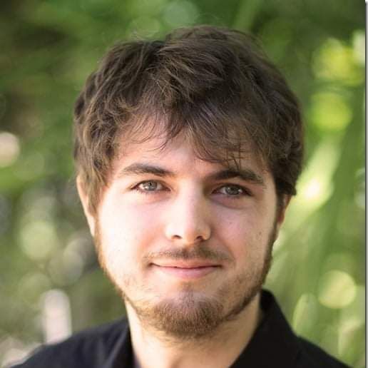 Headshot of Brandon Biggs, a white, brown-haired, blue-eyed mail waring a button-down shirt.