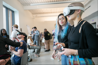 A woman’s mouth hangs open in awe as she tries out a VR demo