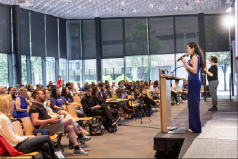 Ria Gualano gives a presentation to a full house in the Verizon Event Center at an XR Access Symposium